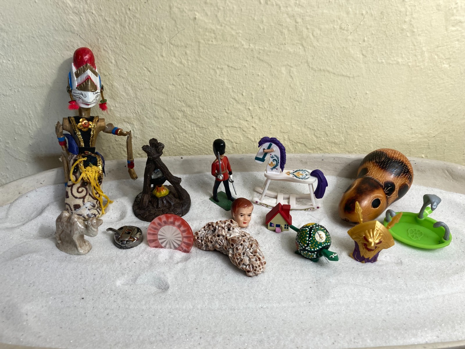 Dozen sand tray figures focus on change, challenges, growth, and stability